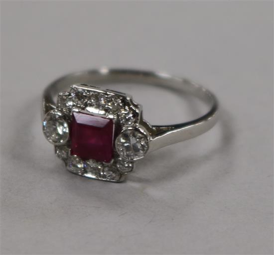 A white metal, ruby and diamond cluster ring, size M.